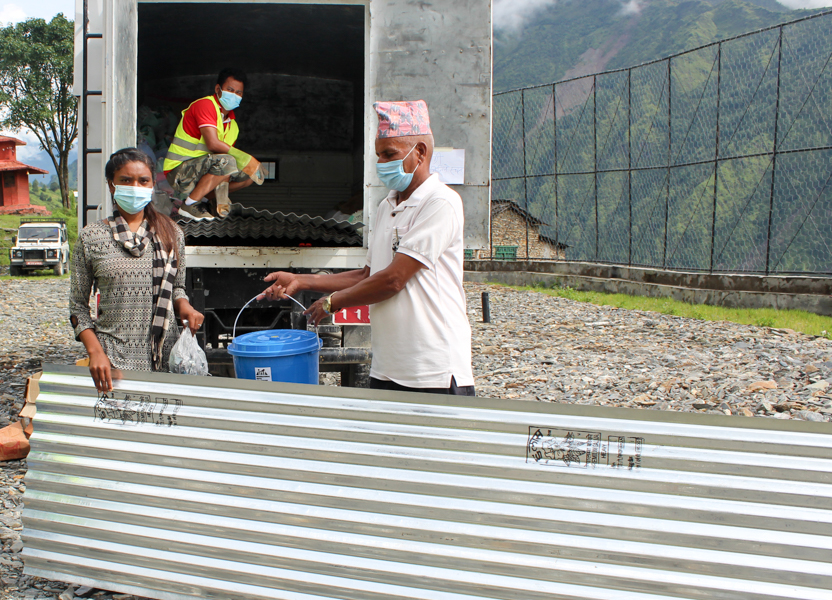 distributing CGI sheet to a landslide affected people in Myagdi district